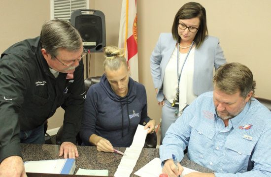 County Judge James T. Browning, Bronson Deputy Clerk Wendy Maragh, Supervisor of Elections Tammy Jones and County Commission chairman John Meeks review election results before announcing them. Browning, Maragh, and Meeks were the canvassing board.