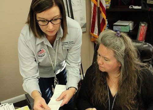 Supervisor of Elections Tammy Jones works with Town Manager Susan Beaudet Friday after the vote was certified.