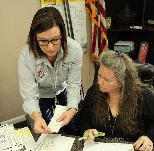 Supervisor of Elections Tammy Jones works with Town Manager Susan Beaudet Friday after the vote was certified.