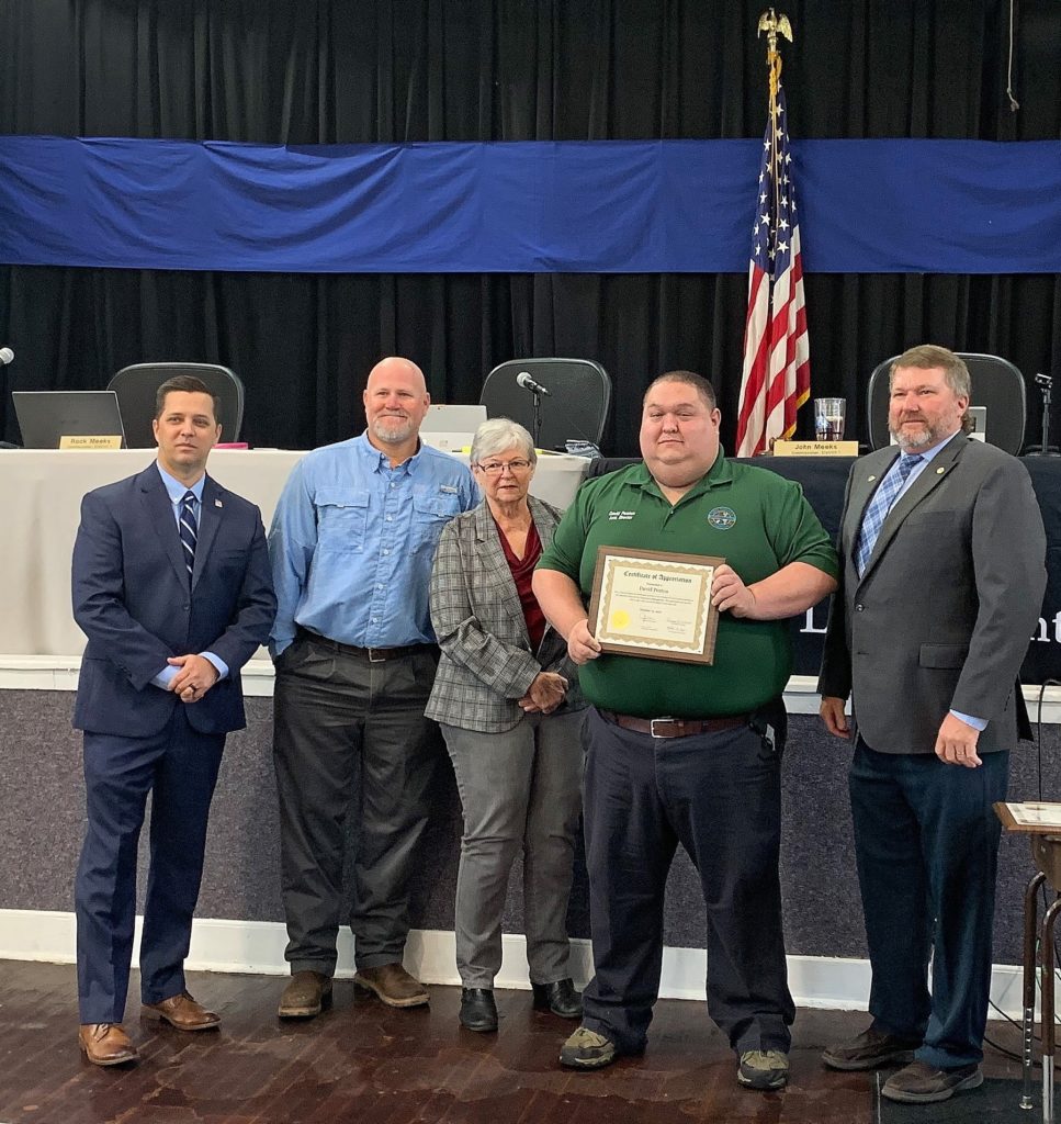 Photo by Alicia Tretheway Procurement Coordinator: Levy County Commissioners Matt Brooks, Rock Meeks, Lilly Rooks, Assistant Director of Emergency Management David Peaton, and Commission Chair John Meeks honor Peaton for his outstanding service to the county.