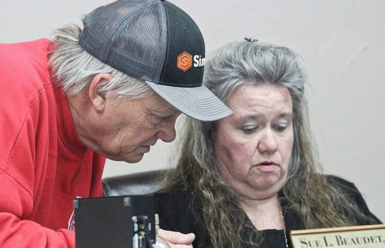 Bronson Fire Chief Dennis Russell confers with Town Manager Susan Beaudet before the Bronson Town Council meeting Monday.