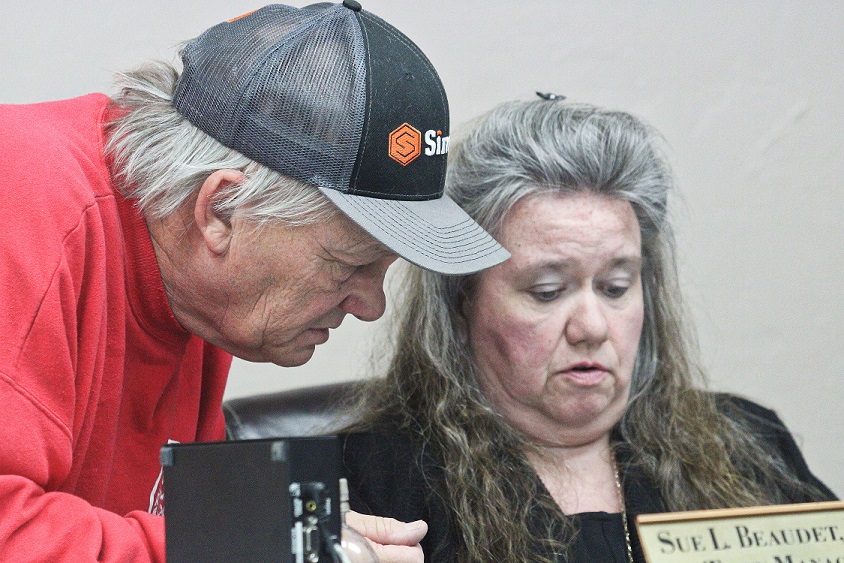 Bronson Fire Chief Dennis Russell confers with Town Manager Susan Beaudet before the Bronson Town Council meeting Monday.