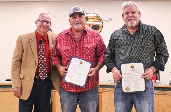 Mayor Jerry Robinson presents certificates to businessmen Jack Penney and Eddie Hodge for voluntarily mowing the hospital grounds.