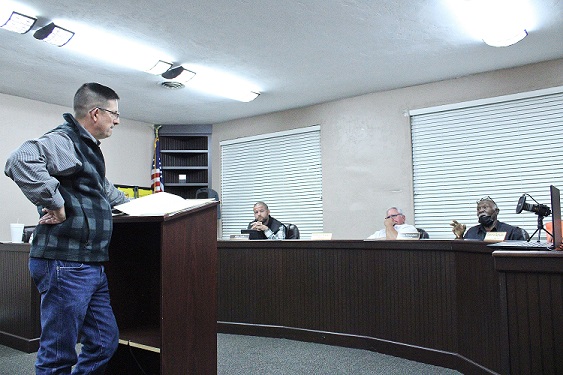 Attorney Doug McKoy listens to Councilman Aaron Edmondson discuss his views on the drainage issues.