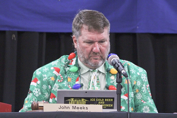 Commissioner John Meeks, the new board vice chairman, dressed in his favorite Christmas sport coat complete with lighted bulbs. He said the Northern Turnpike Extension could destroy the county he loves.