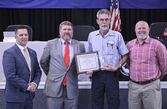 Levy County Transit employee Bruce Haney is honored by Levy County Commissioners Matt Brooks, chairman John Meeks and Rock Meeks for his statewide award.