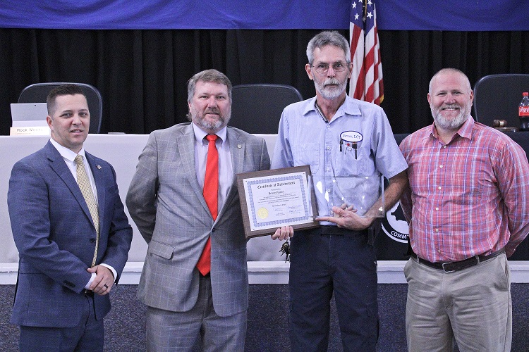 Levy County Transit employee Bruce Haney is honored by Levy County Commissioners Matt Brooks, chairman John Meeks and Rock Meeks for his statewide award.