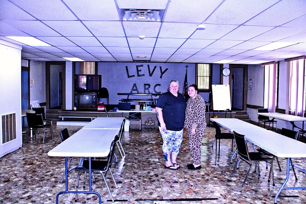 Arc Executive Director Lisa Daniels and Arc Program Director Raylin Hamlin stand in the cafeteria of the old school.