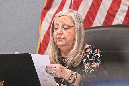 Council President Debra Jones reads from police officer Jeff Holcomb's letter urging the council to postpone a decision on hiring a police chief.