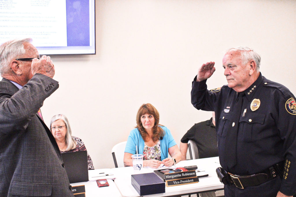 Mayor Jerry Robinson shares a final salute with Police Chief Dennis Strow.