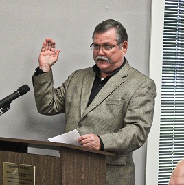 County Judge James T. Brown swears in two Chiefland city commissioners.