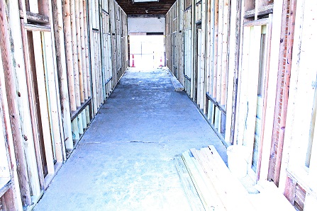 Fresh two-by-fours line the walls of the long hallway known as the Arcade. Work has just begin on renovating the Arcade.