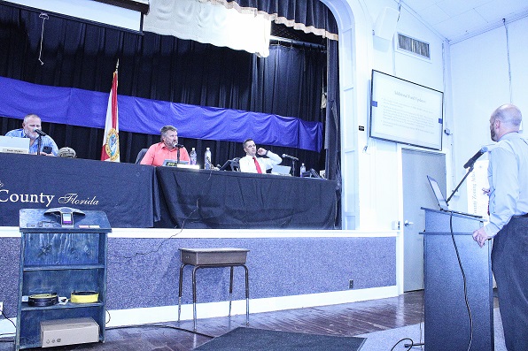 Jared Blanton, the clerk's office financial director and budget officer for the county commission explains the 2023 budget as Commission Chairman Rock Meeks and Commissioners John Meeks and Matt Brooks listen. Commissioner Lilly Rooks isn't pictured.