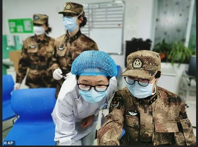 Several of Wuhan's major hospitals as well as two newly built coronavirus hospitals are now being managed by the People's Liberation Army. A military medical worker is pictured taking over the work from a medical worker at Wuhan Jinyintan Hospital on January 26. This Associated Press photo appeared with a story in dailymail.com reporting China appointed its top military bio-warfare expert to take over the Wuhan virus laboratory, sparking conspiracy theories that the Covid-19 virus likely started in the Beijing army. Photo by dailymail.co.uk news article February 14, 2020.