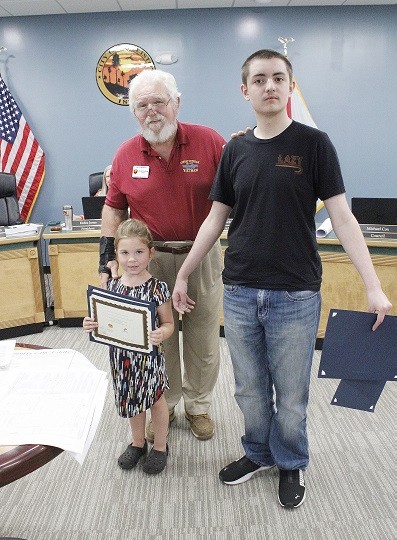 Mayor Charles Goodman honors Students of the Month Corrie Stinson and Jon Kopecky.