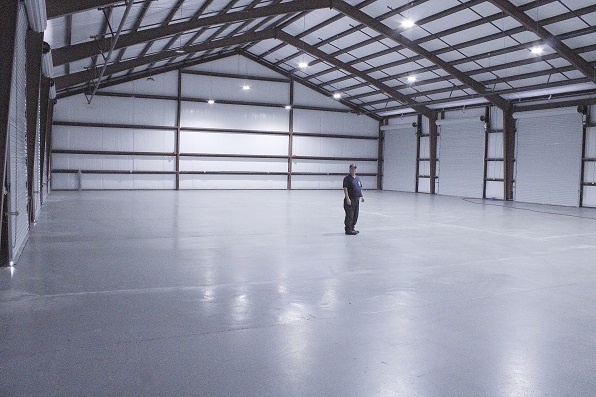 Fire Chief Dennis Russell appears rather small as he stands in the middle of the massive fire bay.