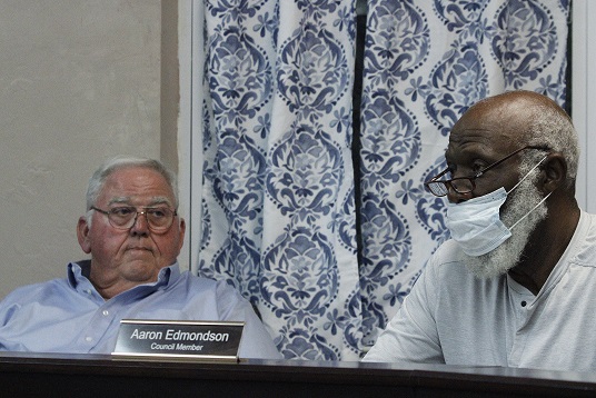 Mayor Robert Partin listens as Councilman Aaron Edmondson raises questions about how the cooperative would provide sewer to the entire town.