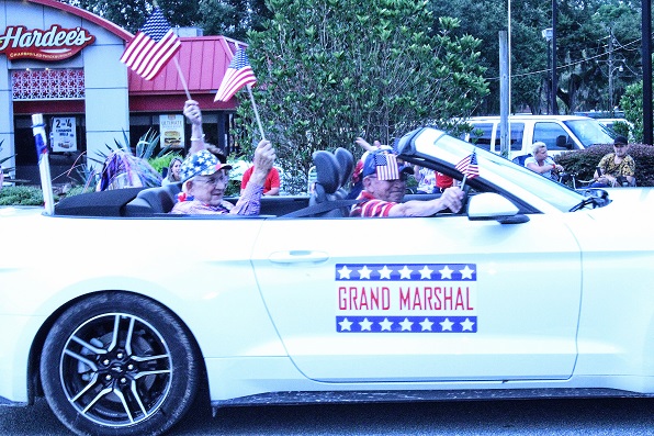 Waving an American flag, Councilman Elihu Ross served as Grand Marshal of the 2022 July 3 parade.