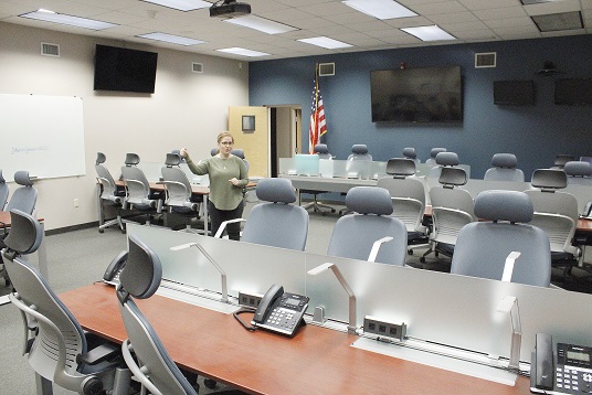 Letha Keene, who works in Levy County Emergency Management, stands in the central communications room used during emergencies, including hurricanes, to gather information on approaching storms and make plans for emergency