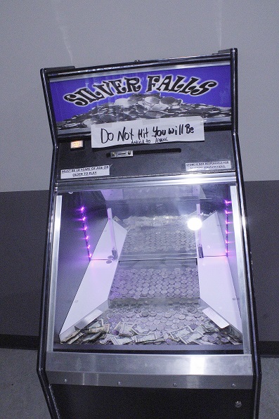 This game was filled with quarters from customers. A handwritten warning at the top says, "Do not hit. You will be asked to leave."