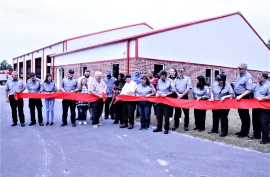 Former Bronson Mayor Beatrice Roberts was given the honor of cutting the ribbon. Pictured from the left are Fire Lt. Bobby Kramer, firefighter Ian Gunter, firefighter McKenzie Durden, firefighter Destin Mock, Councilman Tyler Voorhees, Town Manager Susan Beaudet, Mayor Robert Partin, Councilman-Elect Franklin Schuler, Roberts, Fire Chief Dennis Russell, behind him County Commissioner John Meeks, Cyntha Waters, Behind her Town Councilwoman Sherrie Schuler, Robert Smith, behind him Councilwoman-Elect Virginia Phillips, Safety Officer Jessie Baggett, Auxilliary Bonnie Baggett, firefighter Elizabeth Chazulle, firefighter Mark Smith, Capt. Gail Foote. Not shown Austin Coleman.