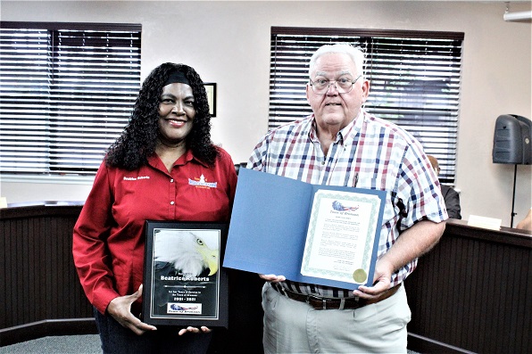 Mayor Robert Partin presents a proclamation to former councilwoman and mayor Beatrice Roberts for her service to the town.