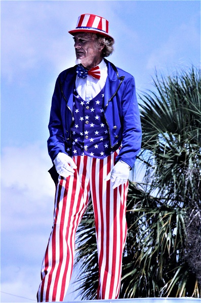 Uncle Jam, portrayed by Duane Schwingel, poses for the crowd as he stands atop a business float.