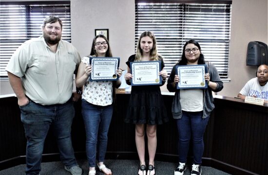 Bronson Town Councilman Tyler Voorhees presents $1,000 scholarships to Christine Porter, Shelby Strickland, and Ingrid Velazquez-Guadawama courtesy of the town council.