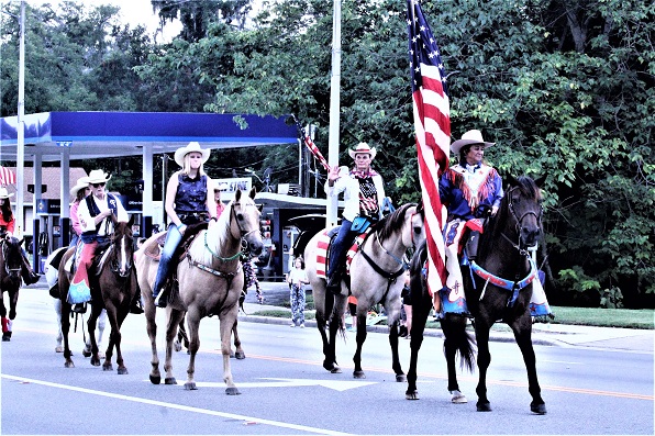 Led by Wendy Wilson carrying the American flag, the equestrian group, one of the crowd favorites, makes its way down Noble Ave at the tail end of the parade.