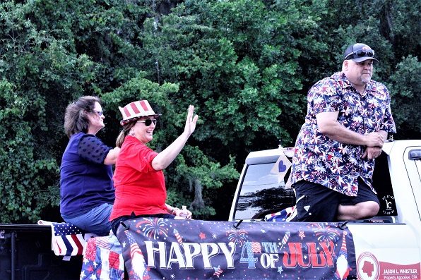 Tax Collector Michele Langford, Supervisor of Elections Tammy Jones, and Property Appraiser Jason Whistler enjoy a bird's eye view of the crowd along the parade route.