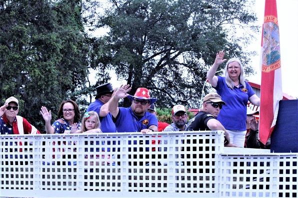 The Williston City Council with President Debra Jones and to her left, City Manager Terry Bovaird wave to the crowd.