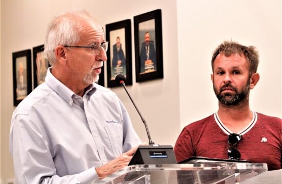 Engineer Walt Nickel explains planned drainage improvements to John Henry Park as resident Joab Penney listens at this week's city council meeting.