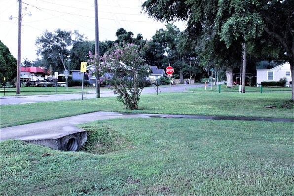 The photo shows a large drainpipe that empties water from the intersection of NW 4th St. and NW 1st Ave. into John Henry Park. Apparently, the natural depression to the right of the culvert will be expanded and improved to hold more stormwater and improve flow into the ground.