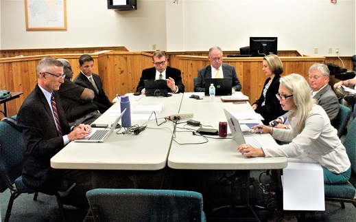 The 8th Judicial Circuit Nominating Commission prepares to interview six judicial candidates vying for the county judge's post. Starting with the two men at the far end and going left, State Attorney Brian Kramer, Commission Chairman Norm Fugate, Rebecca Shinholser, Brent Siegel, Candice Brower, Ronald Bendekovic, Robert Woody, and Christopher Elsey.