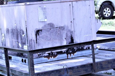 The aging air conditioning unit from the roof of the Levy County Development Department, pictured here after being removed, was so rusty it was leaking water into the building and had to be wrapped in a tarp.