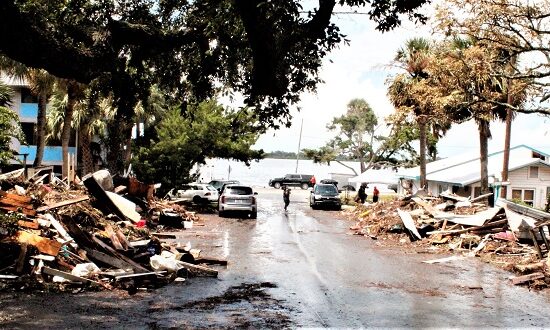 Storm debris is stacked on both sides of Third Street in Cedar Key. The Faraway Inn on the right side of the street sustained heavy damage from Idalia but still has a rental cottage available.