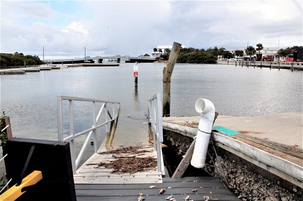 The city marina dock appears to be sunk beneath the water.