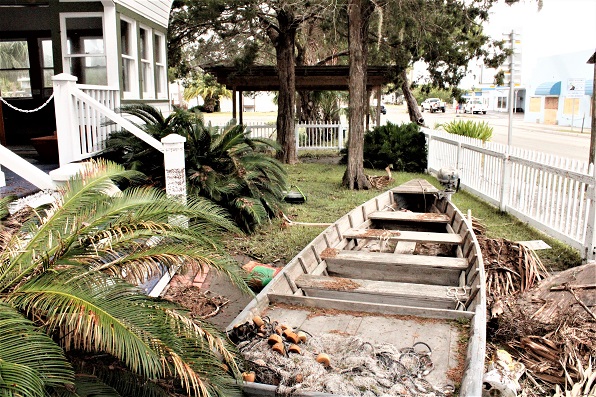 An historic mullet boat displayed next to the museum floated from its display shed at the top of the photo, through a pair of trees and came to rest facing the shed.to have sustained a lot of damage from the looks of things. but looks can be deceiving. Many businesses with first floor dining areas or lounges were hard hit. The photo shows a piece of a dock that came to rest on Dock Street during the storm surge.