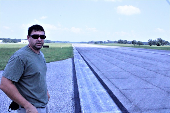 Airport Supervisor Benton Stegall stands alongside the airport's longest runway which is nearly 7,000 feet long. He said there are no plans to extend the runway. Such a move would require city council approval. The runway has ample length for all jets using the airport.