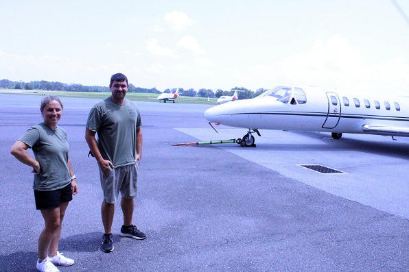 FBO Supervisor and Administrator Kelly Hars is pictured with Airport Supervisor Benton Stegall near a jet aircraft based at the Williston Municipal Airport. Two other jets can be seen parked on the other side.